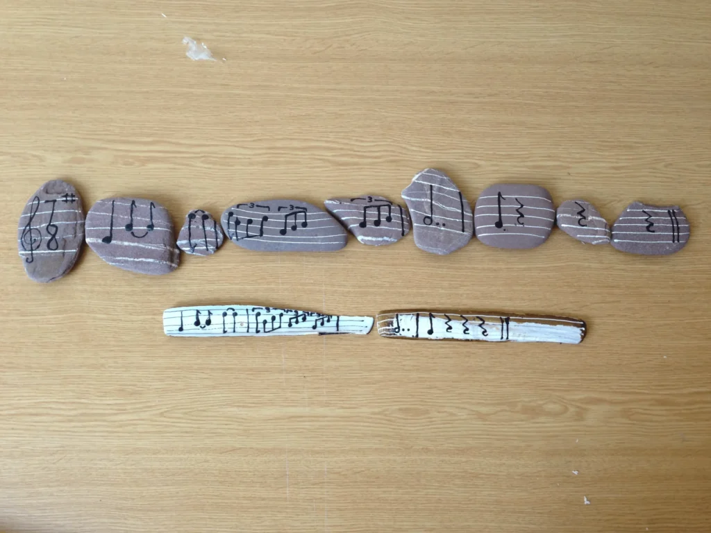 pebbles with music notes written on them